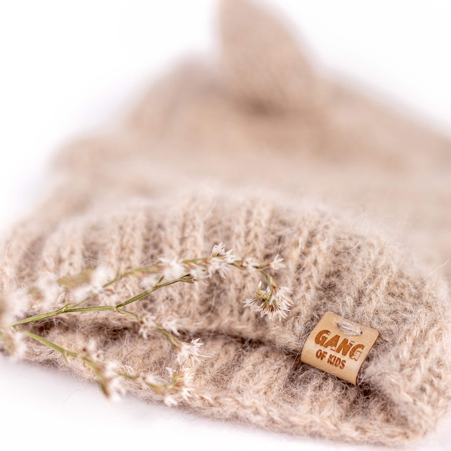 Detail of the soft hand-knitted alpaca wool texture and contrasting Light Gray inner ear of the Fairy Balaclava.