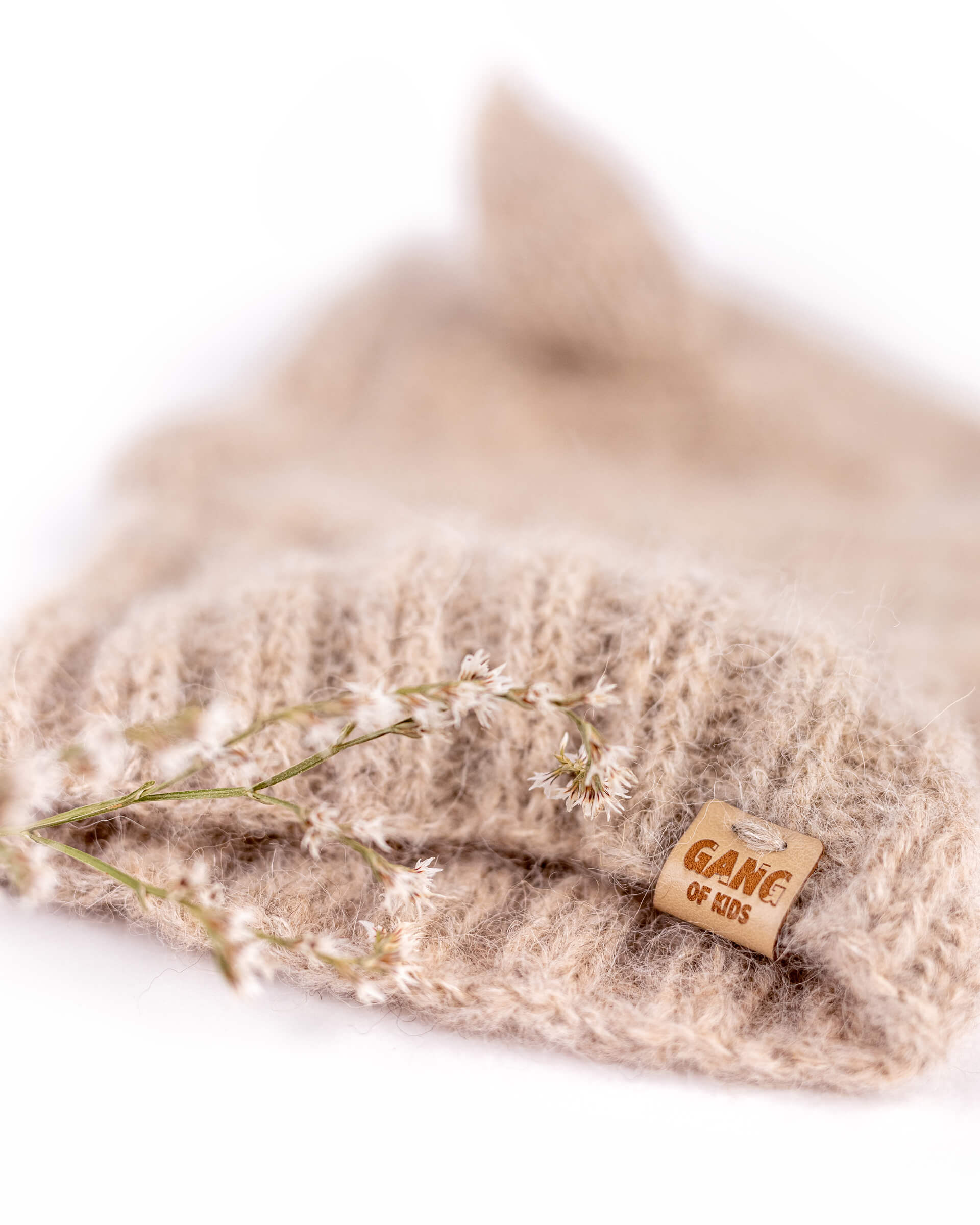 Detail of the soft hand-knitted alpaca wool texture and contrasting Light Gray inner ear of the Fairy Balaclava.