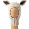 Bambi Balaclava, a knitted balaclava for kids with ears, shown in wheat with pearl grey spots on a wooden display head.