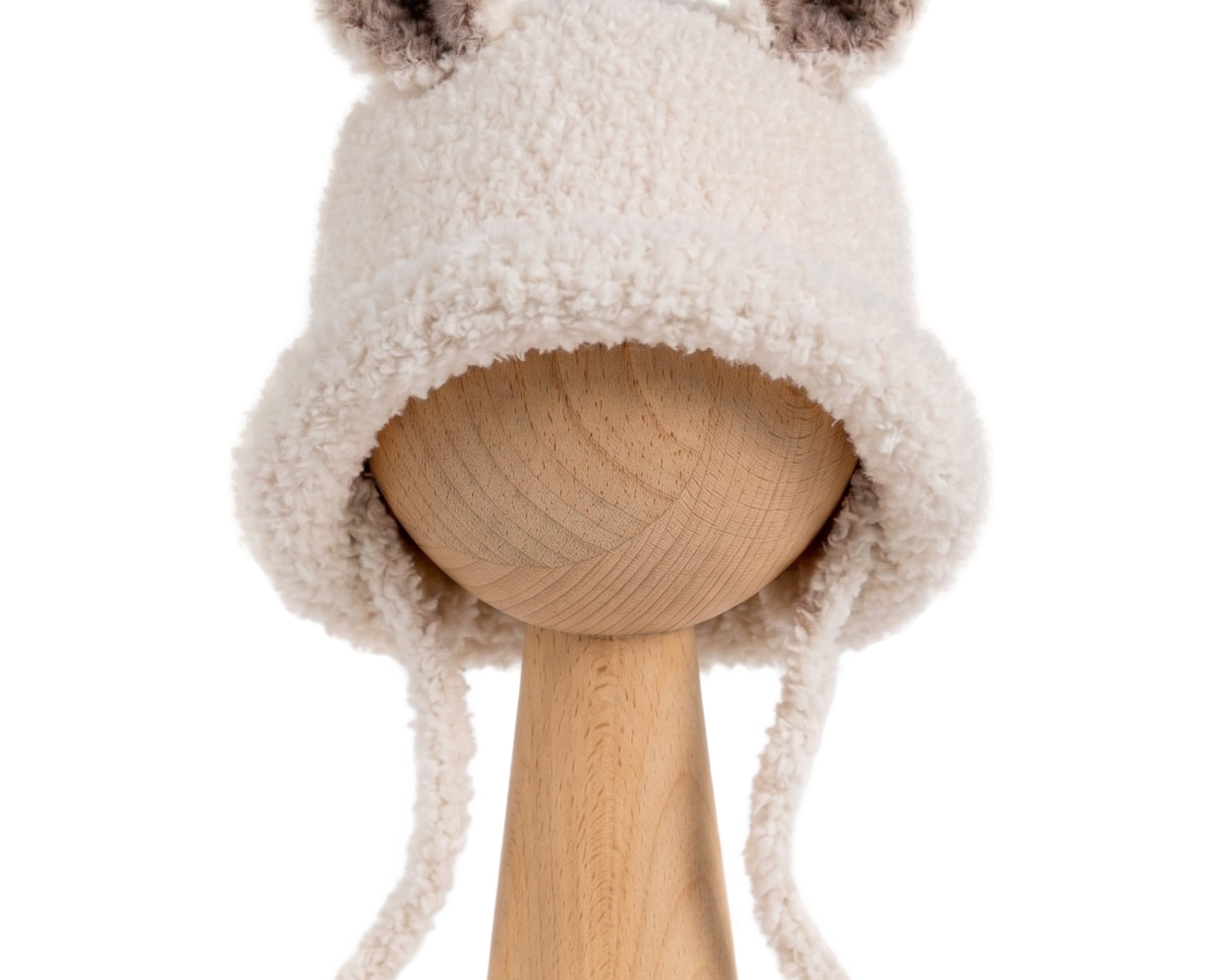 Bucket Bear Hat, a knitted winter hat with bear ears, shown in cream boucle yarn with tie-under-chin closure.