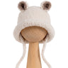 Bucket Bear Hat, a knitted winter hat with bear ears, shown in cream boucle yarn with tie-under-chin closure.